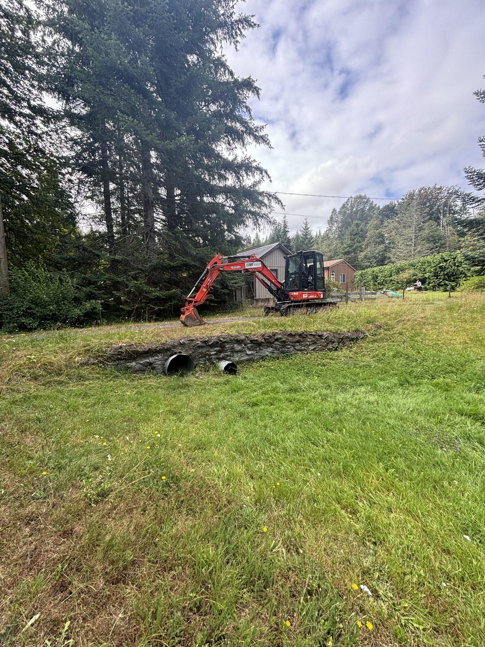 Natural boulder retaining wall site prep Vancouver Island