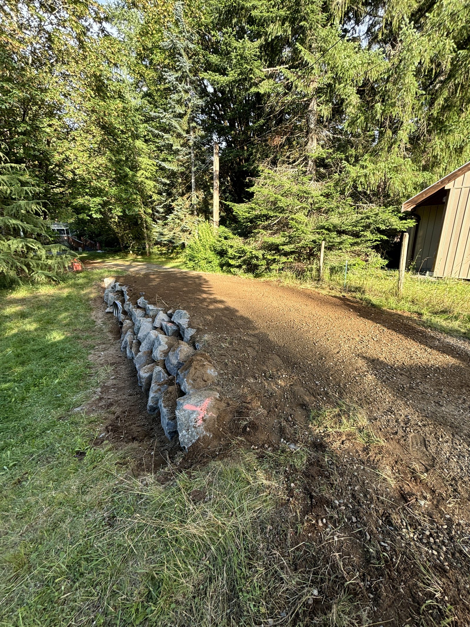 Natural boulder retaining wall finished Vancouver Island